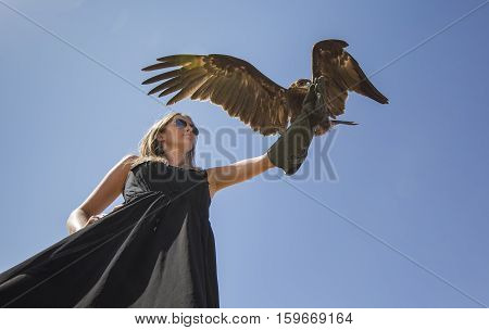 Young woman with Greater Spotted Eagle (clanga clanga)