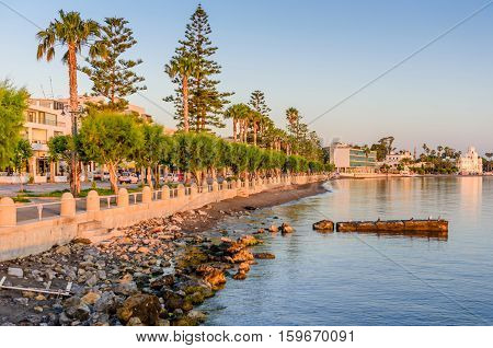 A picturesque promenade with palm trees in the soft morning light in Kos town, Kos island, Dodecanese, Greece.