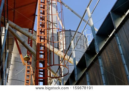Plant for the drying of grain on the background of sky on a bright sunny autumn day