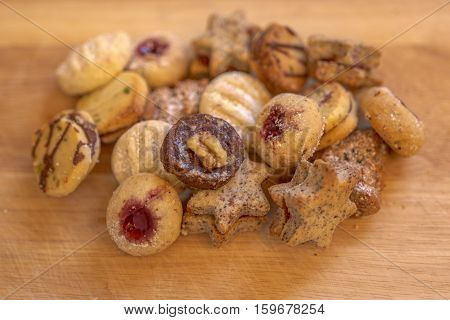 Several christmas cookies on rustic wooden plate