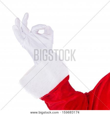 Santa Claus hand in white glove and red costume showing Okey O.K. sign gesture isolated on white background