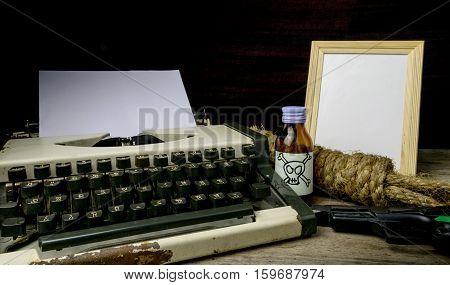 Typewriter with paper page and poison and gun. Concept writer Romance Suspense