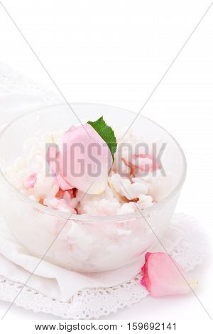 Risoto prepared with petals of rose. Isolated on white background.