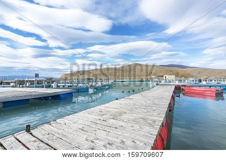 Salmon Fish farm floating on the glacial waters of Wairepo Arm Twizel South Island New Zealand
