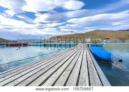 Salmon Fish farm floating on the glacial waters of Wairepo Arm Twizel South Island New Zealand