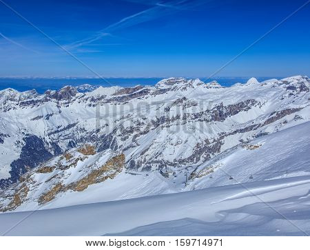 View from Mt. Titlis in Switzerland in winter. Titlis is a mountain, located on the border between the Swiss Cantons of Obwalden and Bern.