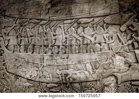 Wall image of a boat and people in ankor wat cambodia