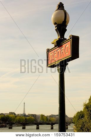 Parisian Metro Sign With The Eiffel Tower In The Background