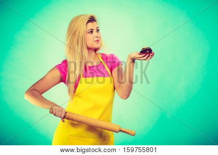 Woman Holding Rolling Pin And Chocolate Cupcake