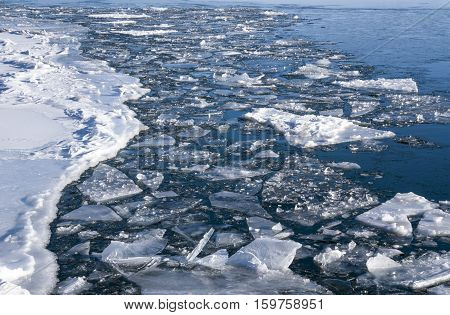 Crumble in spring ice floe on the river
