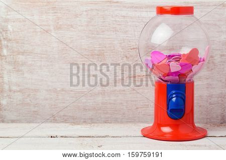 Valentine's day background with gumball machine and heart shapes