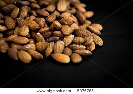close up almonds nuts on black backgroundselective focus.