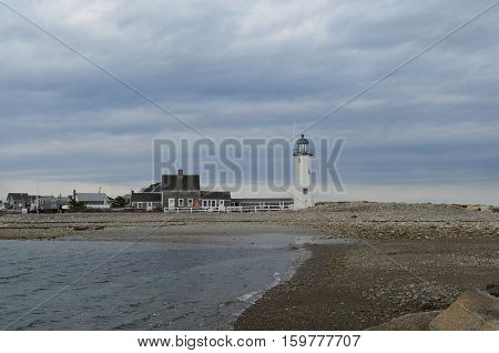 Beach rocks and Old Scituate Light on a stormy day.