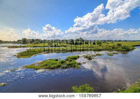 River outside the city on a windy summer day, horizontal frame