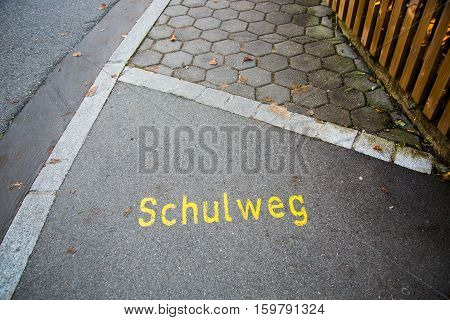 School way written on paving stone, sign