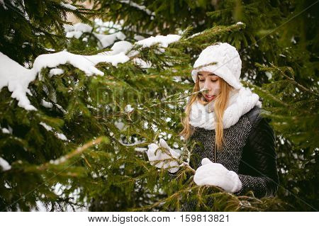 Young Woman In A Forest With Fir And Pine Trees On The Street, Hands Touch The Branches Of Trees, Co