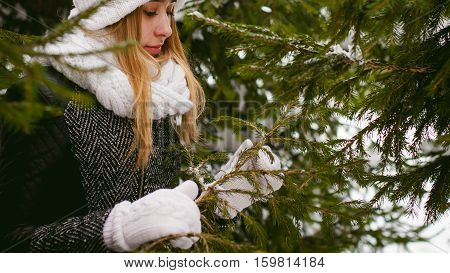 Young Woman In A Forest With Fir And Pine Trees On The Street, Hands Touch The Branches Of Trees, Co