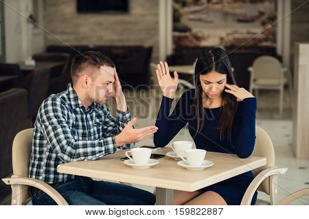 Young couple arguing in a cafe. Relationship problems