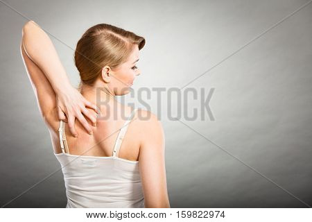 Woman Scratching Her Itchy Back With Allergy Rash