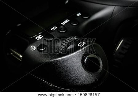 Shutter button on a DSLR camera, close up image isolated on black background