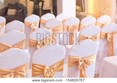 beautiful chairs decoration with ribbon in wedding event hallselective focus.