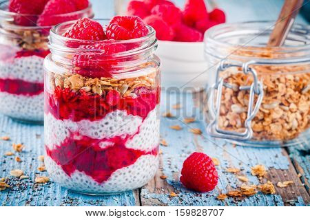 Chia Pudding With Raspberry Sauce, Granola And Fresh Raspberries