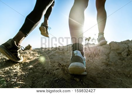 Runners training outdoors, closeup on low section body
