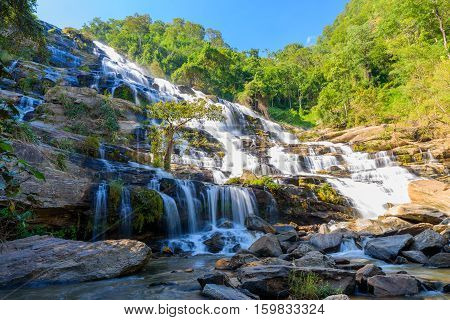 Mae Ya waterfall with green trees and blue sky backgroundat Doi Inthanon National ParkOne of the famous waterfalls of Chiang Mai.