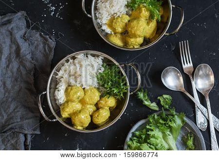 Vegetarian quinoa and broccoli meatballs with curry sauce and rice. Vegetarian lunch table top view