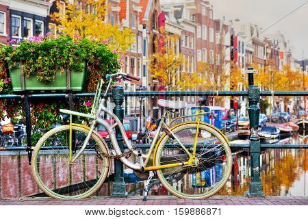 Bycicle parked at the bridge in Amsterdam