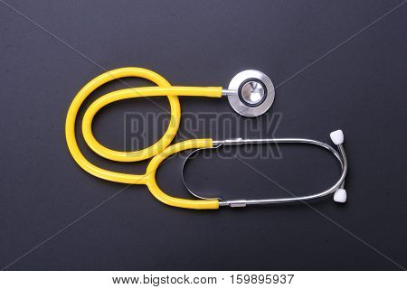 Red heart and a stethoscope on desc.