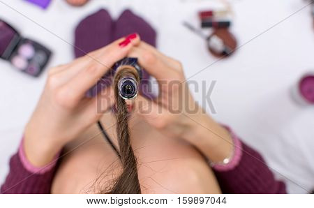 Point Of View Of Woman Using Curling Iron