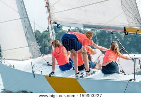 Sailing yacht race. Team athletes participating in the sailing competition