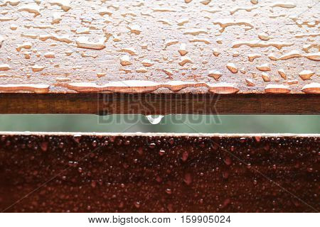 Drop of water on wood with raindrop after a rain with copy space.