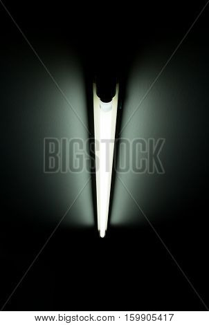 Detail of a fluorescent light tube on a wall. fluorescent light tube with copy space for any design