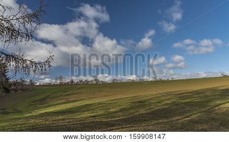Green Field With Blue Sky And White Clouds In Autumn Time