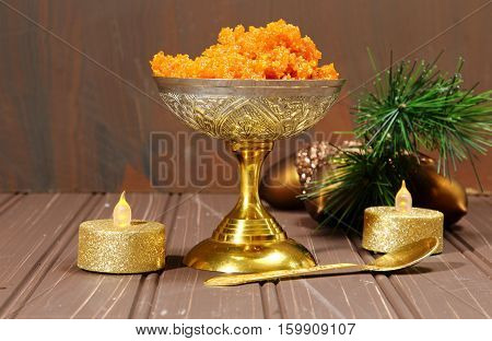 Gajar halwa or carrot dessert in a bowl with festive moosy dark background