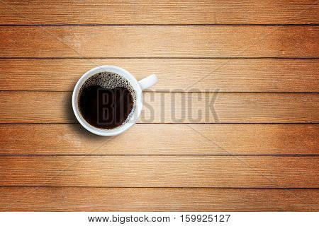 Cup of coffee on wood table background with copy space for any design. Coffee Mug on Wooden Table
