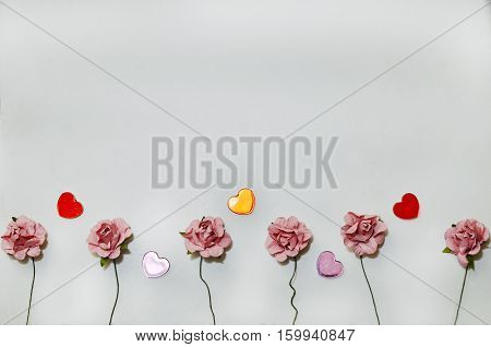beautiful card for the holiday of love. Background for Valentine's Day. Postcard for weddings. Pink flowers on a white background scattered small hearts