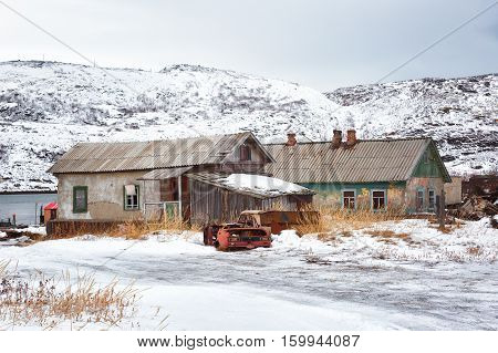 Old Wooden Houses And The Remains Of Rusty Cars Arctic Barents Sea The Village Of Teriberka