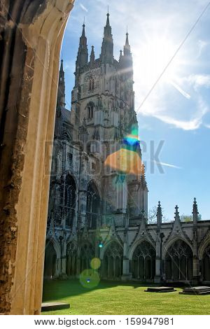Canterbury, UK - May 1, 2011: With Special sun flare. Cloister Garden in Canterbury Cathedral in Canterbury in Kent of the UK. It is one of the most famous cathedrals in England. It is the Archbishop of Canterbury Cathedral.