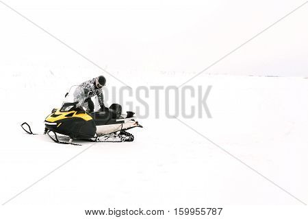 Man on snowmobile. Recreation concept on nature in winter holidays. Winter sports.