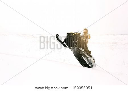 Man on snowmobile. Recreation concept on nature in winter holidays. Winter sports.