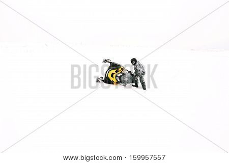 Man on snowmobile. Recreation concept on nature in winter holidays. Winter sports.