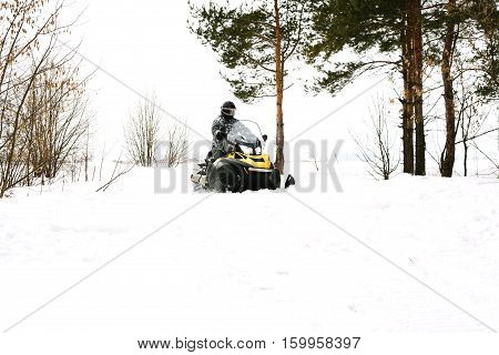 The sportsman on a snowmobile. Recreation concept on nature in winter and New Year holidays. Winter sports.