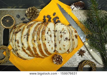 Fresh baked raisins bread sliced on granite board holiday concept