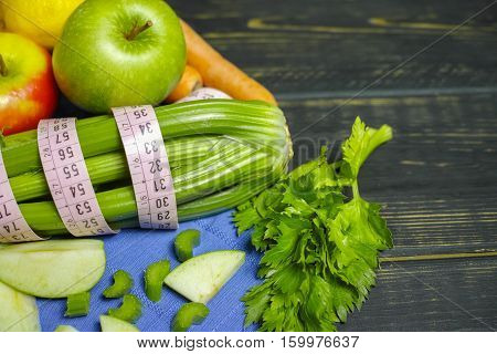 Green vegetables and fruits - celery shoots and apples healthy fitness diet concept