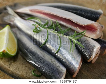 fishes herrings with lemon on a chopping board