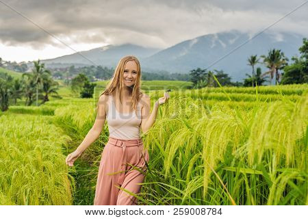 Young Woman Traveler On Beautiful Jatiluwih Rice Terraces Against The Background Of Famous Volcanoes