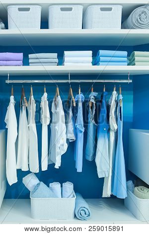 Clean Clothes Hung On Hangers Or Folded On Shelves, Kept On Wardrobe At Home.